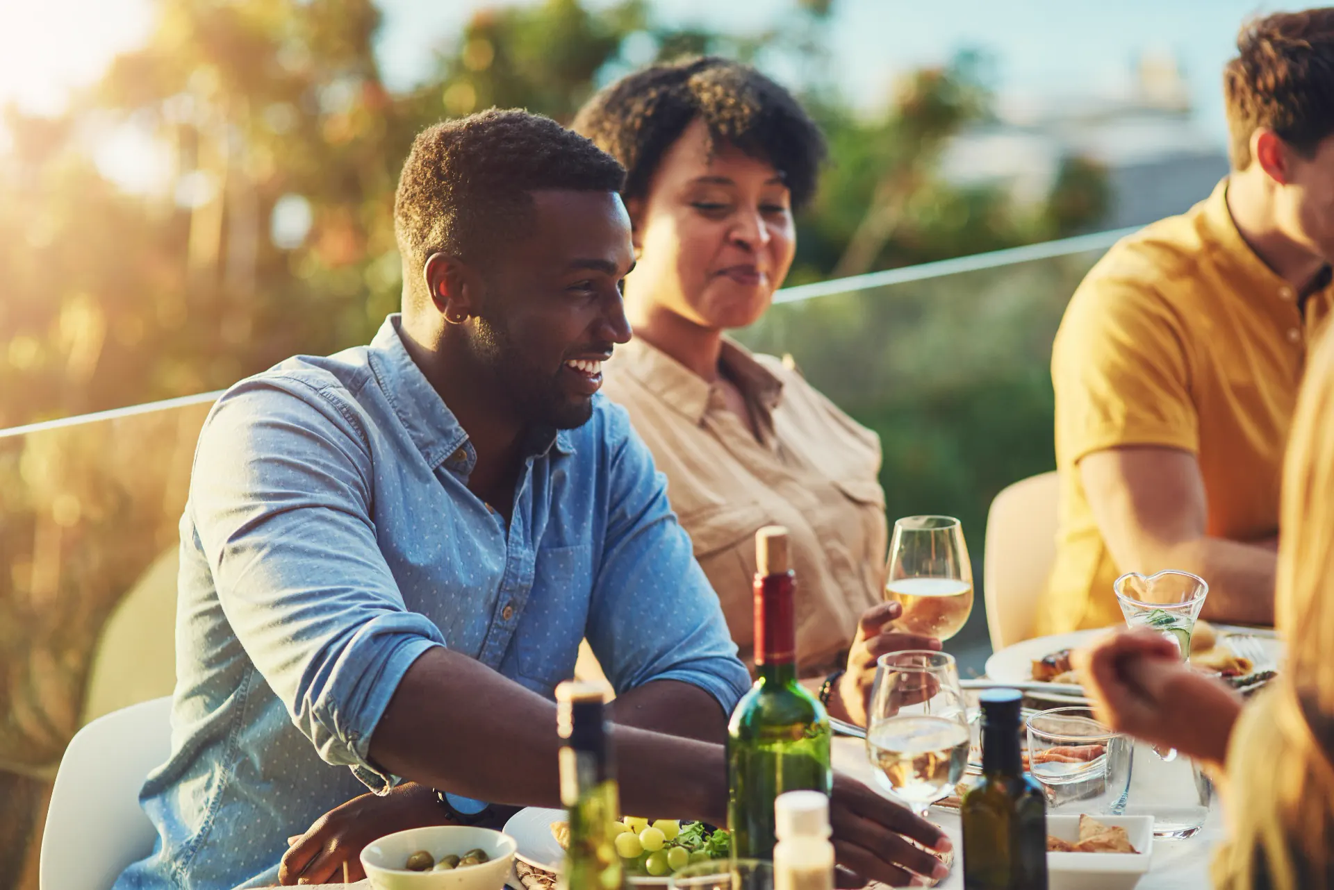An intimate rooftop dinner at dusk with candlelit tables and city views